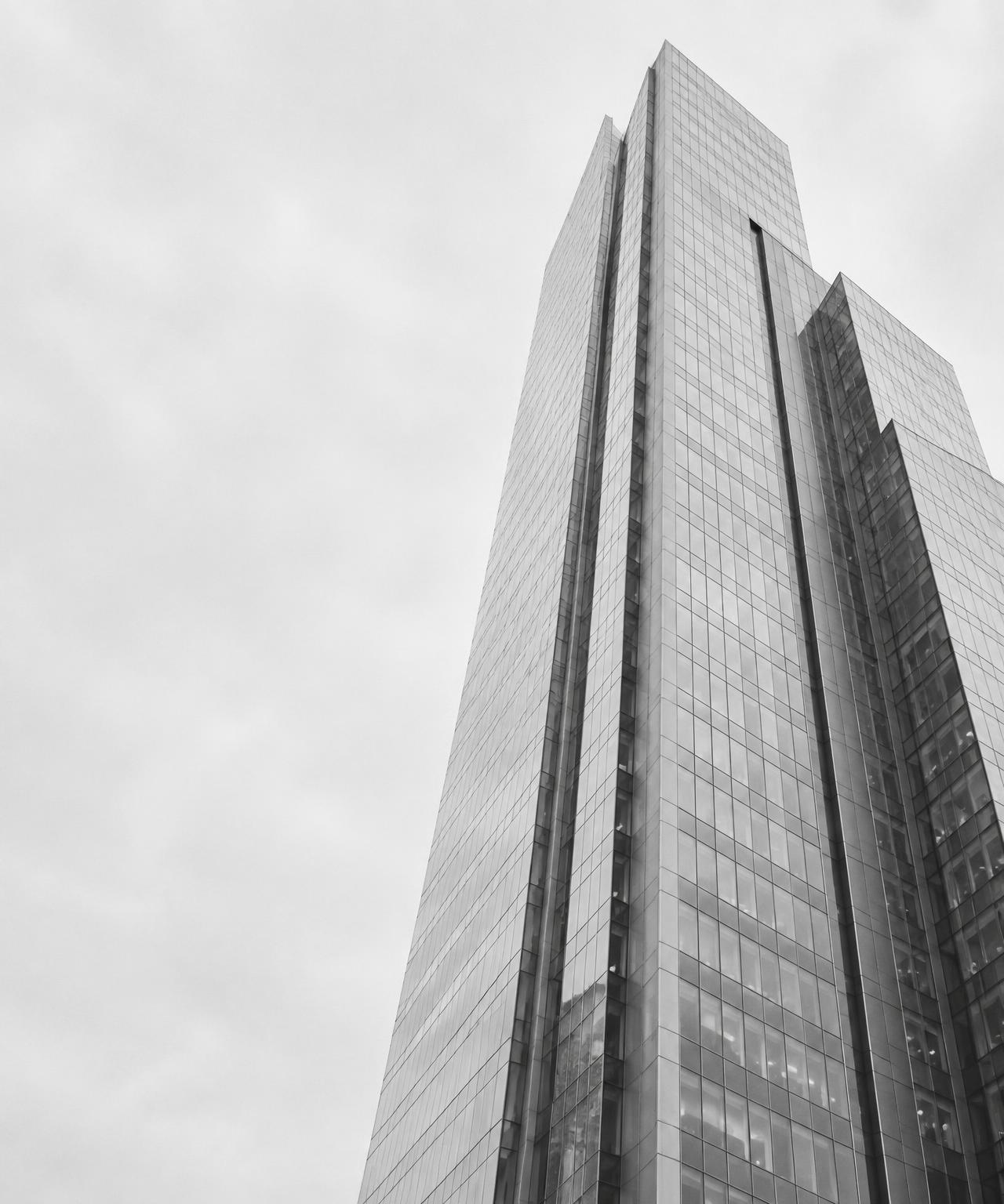 Abstract glass tower rising into a pale sky